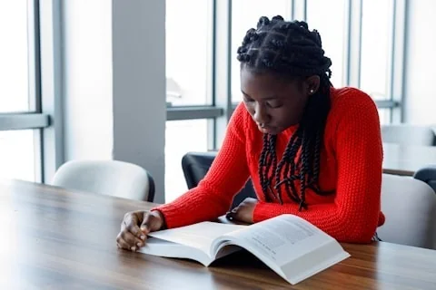 Student reading red shirt