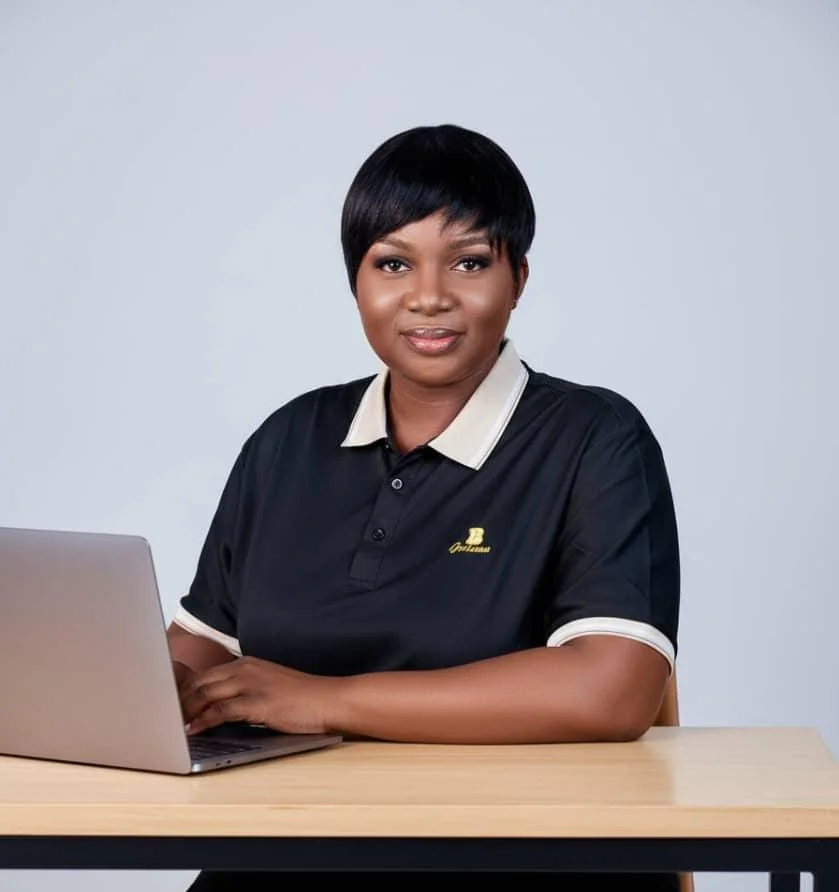 Racheal Oyedepo working at laptop